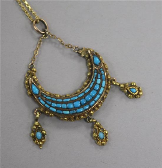 A late 19th century Indian? yellow metal and turquoise set crescent drop pendant, on a gilt metal chain, pendant 31mm.